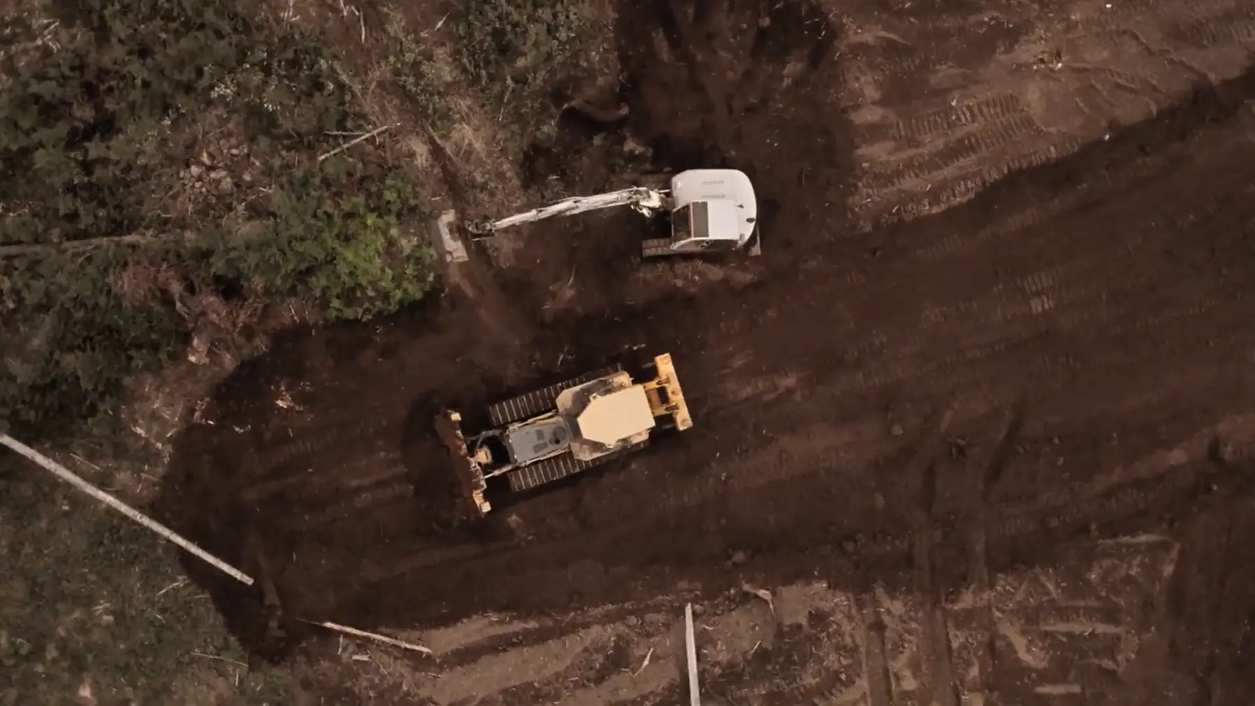 Aerial view of an LPG dozer and excavator clearing a wooded lot