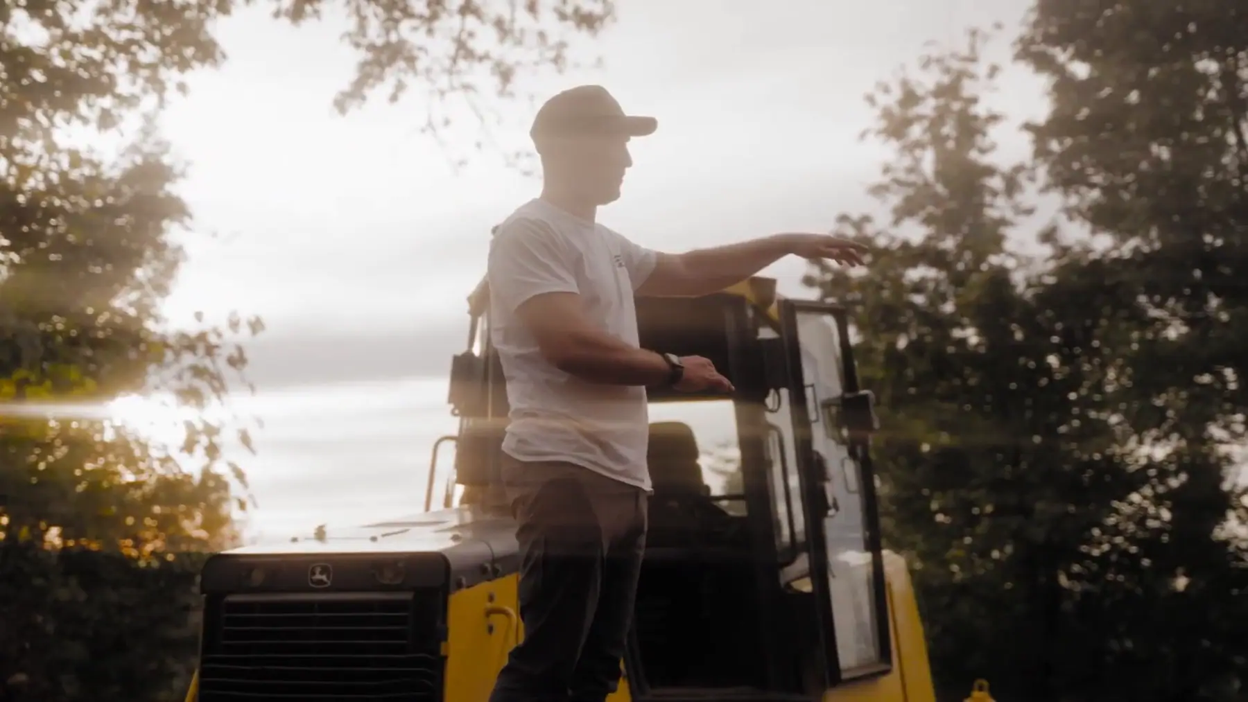 LPG crew member on a dozer at sunset, pointing out the next pass