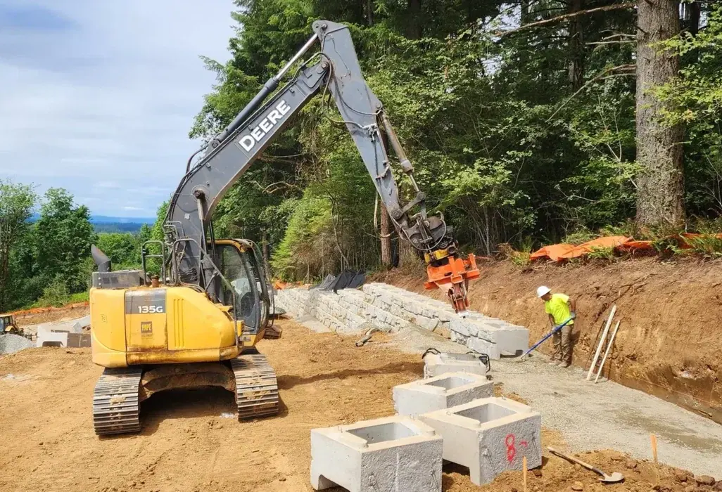 LPG Deere 135G excavator setting retaining wall units